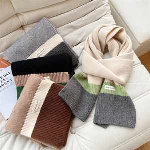 Three-color striped knit scarf for women with soft textured fabric and brand label
