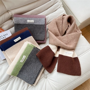 Three-color knitted scarf for winter featuring soft wool texture and brand logo label