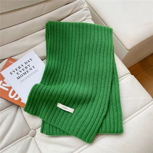 Detail of bright green 100% wool scarf showing high-quality ribbed knit texture