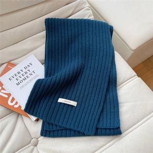 Detail of deep blue knitted scarf made of 100% pure wool with premium ribbed texture