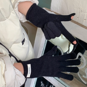 Detail of 100% wool knitted gloves showing the index finger opening for touchscreen use