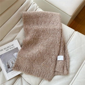 Close-up of thick knit scarf texture in camel with premium alpaca blend material