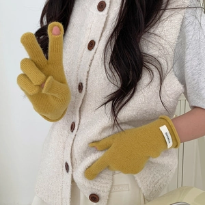 Detail of mustard yellow 100% wool knitted gloves featuring a versatile flip-top design