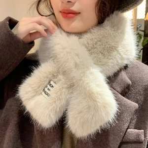 Detail of soft cream faux fur scarf with fashion woven label and crossover design