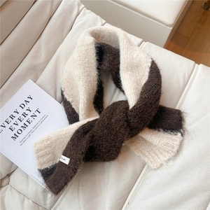 Detail of chunky knit scarf showing plush texture and brown beige color block design