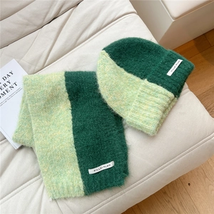 Detail of green bicolor chunky knit scarf and beanie with soft mohair texture