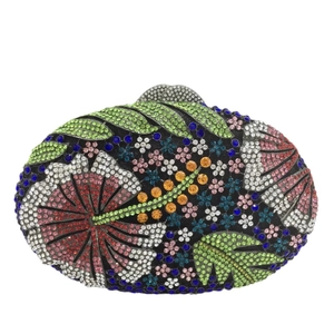 Detail of floral rhinestones on oval evening clutch bag with tropical hibiscus pattern