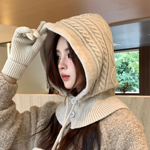 Close-up of cream knit balaclava with cable patterns and matching winter gloves set