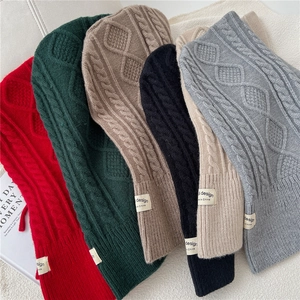 Flat lay of cable-knit balaclava scarves in red, green, khaki, black and grey colors