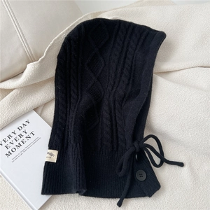 Detailed cable knit texture of black Balaclava scarf with side buttons and drawstring