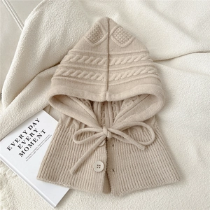 Detail of oatmeal knit balaclava with cute cat ears, cable texture and buttons