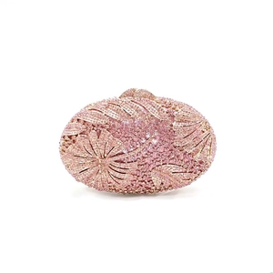Macro shot of pink floral rhinestone patterns on a luxury evening clutch bag
