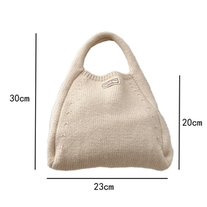Size specifications of solid color knit handbag showing height 30cm and width 23cm