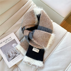 Close-up of winter knit striped scarf with warm faux fur trim and handmade label