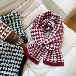 Winter houndstooth knit scarf set in assorted colors displayed on a cozy sofa