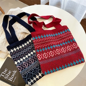 Flat lay of knit tote bags featuring ethnic geometric patterns in navy and red colors
