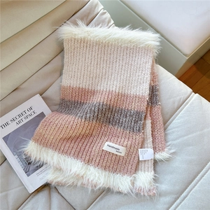 Detail of striped knit scarf with plush faux fur trim and Handmade fashion label