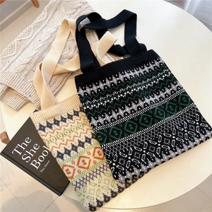 Close-up of bohemian geometric jacquard patterns on knitted tote bags with soft textures