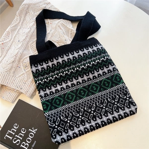 Detailed close-up of knitted tote bag with geometric pattern and thick shoulder strap