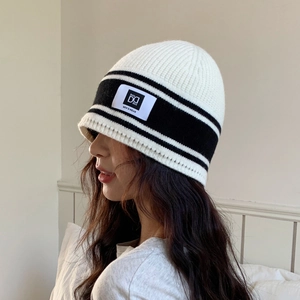 Cozy white knitted beanie with black stripes and brand patch for autumn winter warmth
