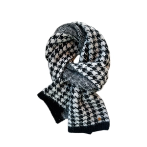 Classic black and white houndstooth knit scarf with thick warm texture for winter