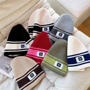 Striped knit beanie hats for women and men in various colors for winter warmth
