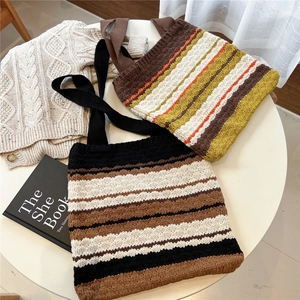 Minimalist striped knit tote bags in retro colors displayed on a white table
