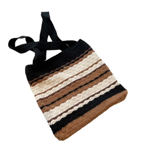 Striped knit tote bag with black brown and beige horizontal patterns and broad shoulder strap