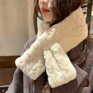 Detail of soft cream faux fur neck warmer scarf worn with a brown wool coat