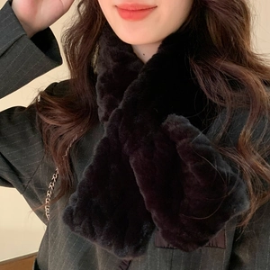 Detail of soft black faux fur scarf with cross-over design on a female model