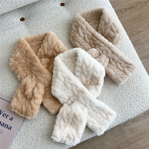 Close-up of winter plush neck warmer scarves with thick knitted texture in neutral colors