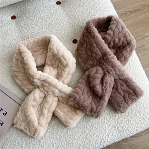 Detail of cross-knot plush neck warmer showing knitted twist texture and soft faux fur