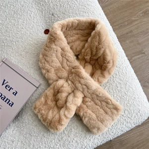 Detail of camel plush scarf with wavy texture and dark decorative button closure