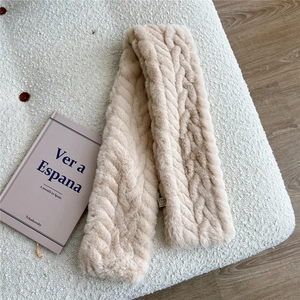 Detail of cream cable knit faux fur scarf showing plush texture and cross-weave pattern