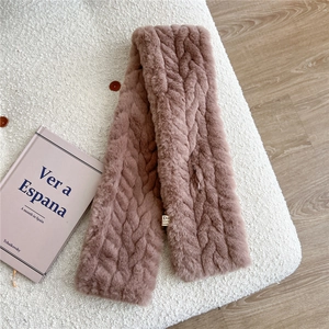 Detail of faux fur winter scarf in dusty pink with woven texture and laundry label