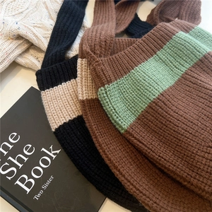 Detail of thick ribbed knit texture and striped patterns on handmade tote bags