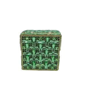 Detailed front view of emerald green crystal encrusted evening clutch with gold metal frame