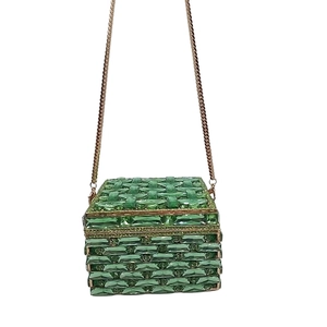 Detail of square green crystal clutch bag with emerald-cut stones and gold chain strap