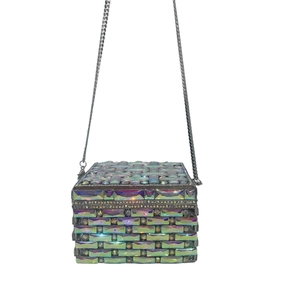 Detailed close-up of woven iridescent crystal jewels and rhinestones on a square clutch bag