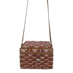 Macro view of rose gold crystal clutch bag with luxurious diamond-encrusted weaving detail