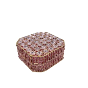 Macro detail of octagonal pink rhinestone evening bag with gold-tone metal frame