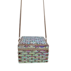 Detailed macro of crystal evening clutch bag with iridescent tiles and gold chain strap