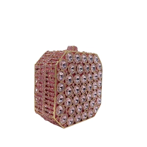 Detailed close-up of pink octagonal rhinestone clutch bag with gold metallic frame