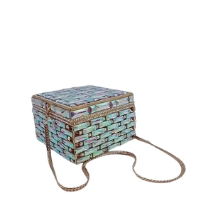 Detail of crystal clutch bag with iridescent blue sequins and golden metal chain