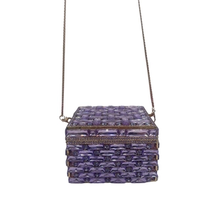Detail of purple crystal clutch featuring hand-woven rhinestones and metallic chain