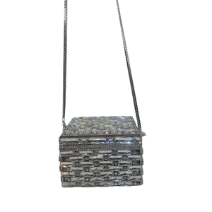 Detailed macro of crystal evening clutch bag with sparkling woven rhinestone texture and chain