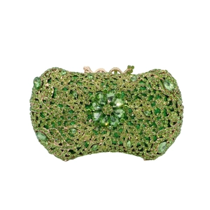 Detailed macro view of the luxury green floral rhinestone clutch with gold floral lock clasp