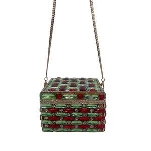 Close-up of square evening clutch with red and green crystal mesh and gold chain
