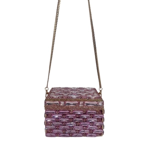 Detailed macro of pink and purple crystal clutch with geometric rhinestone patterns