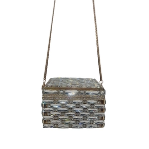 Macro detail of square crystal clutch with gold trim and rhinestones for evening gala
